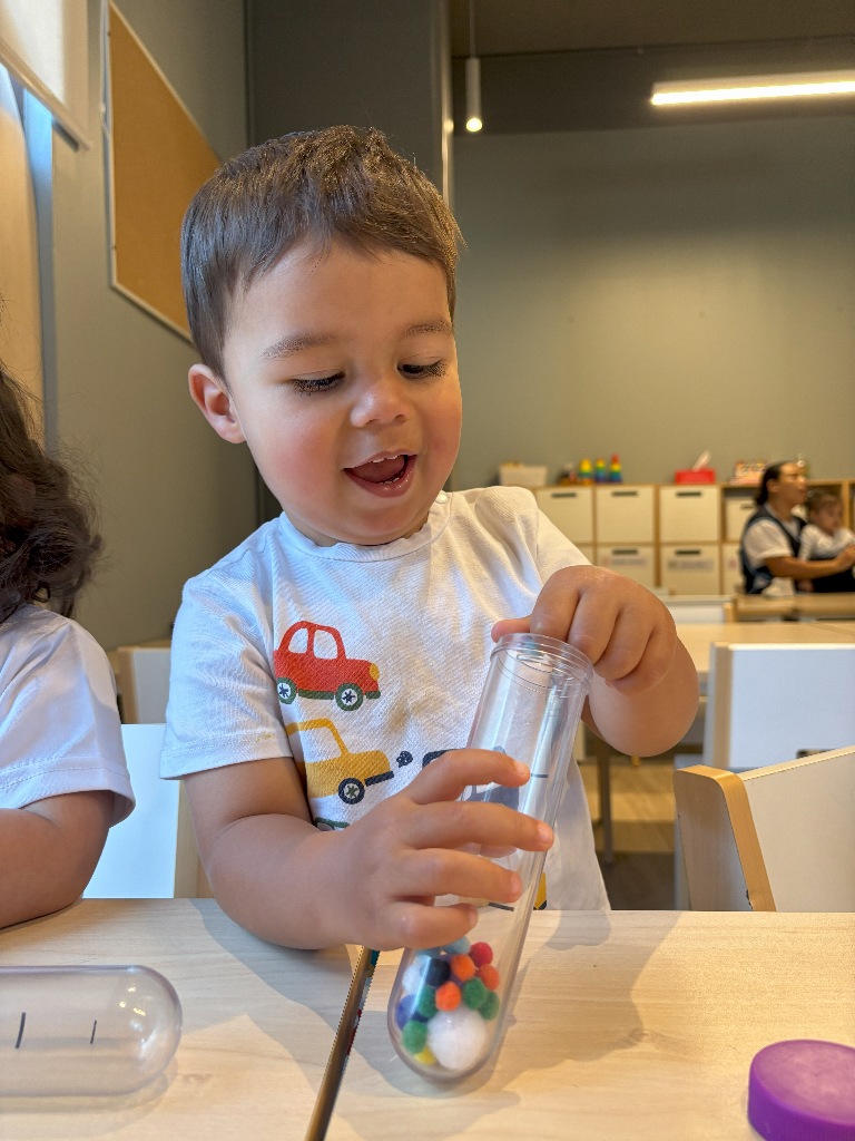Lenguaje verbal, pequeño jugando con pequeñas bolas de tela, aprendiendo en Colegio APDE Connections Cayalá